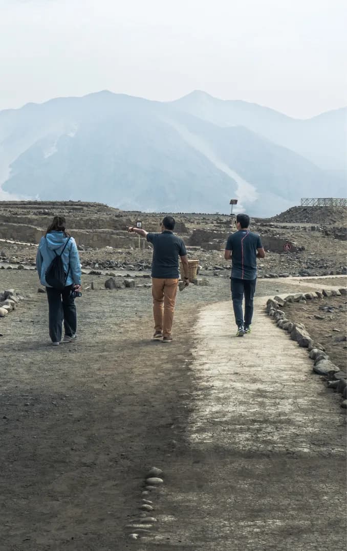 Tour group at Caral enjoying guided archaeological experience